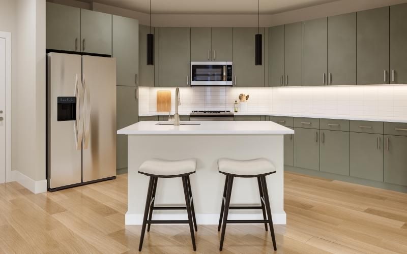 a kitchen with an island with green cabinets